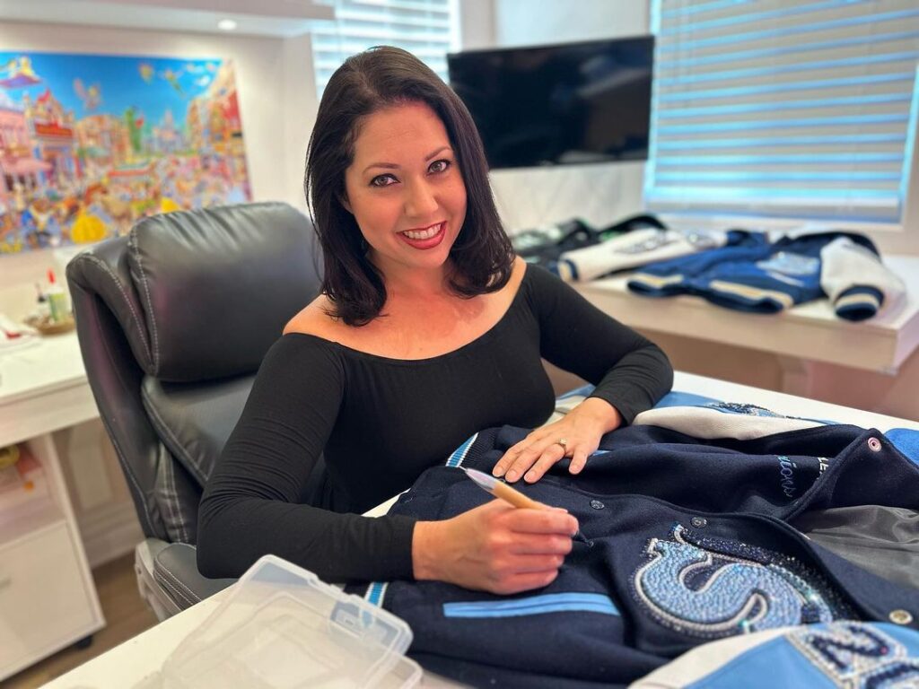 Erica hand-blinging a jacket at her studio desk